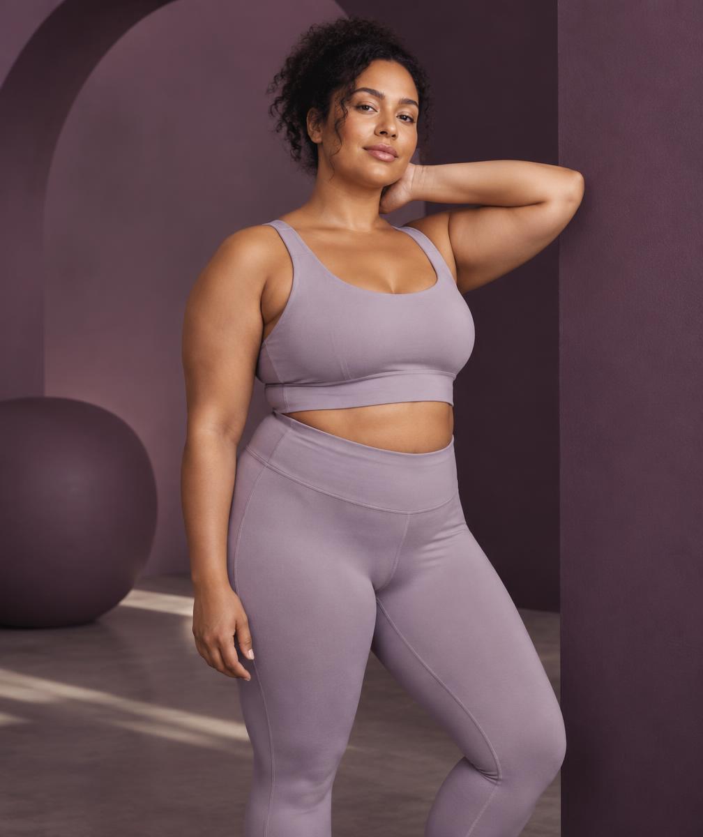 Woman in lilac activewear in a sculptural studio